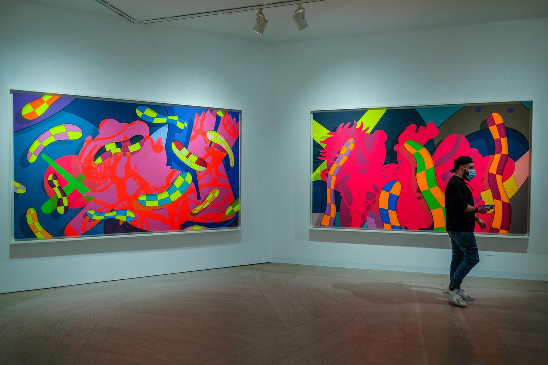 Neon colored abstract paintings. Inside the KAWS exhibit at Brooklyn Museum